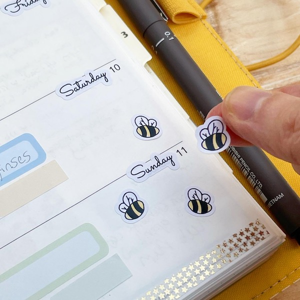 Cute bee stickers on a page in a planner